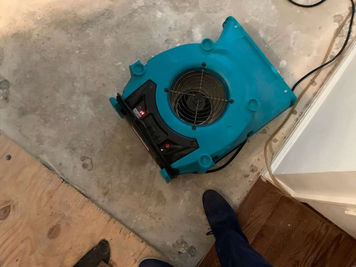 Air mover drying subfloor during Leak Detection & Repair in Warwick